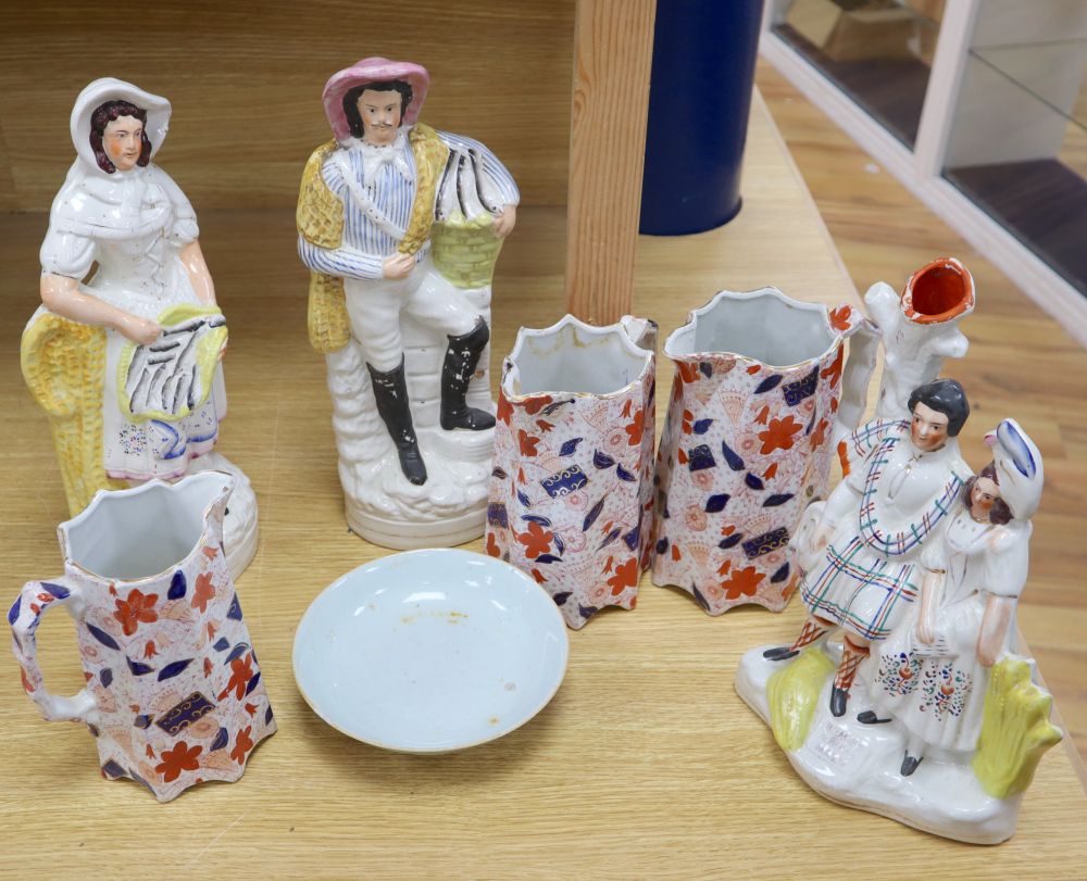 A pair of large Staffordshire figures, a similar Burns and his Mary group, 30cm, a graduated set of three Imari jugs and a Chinese foot